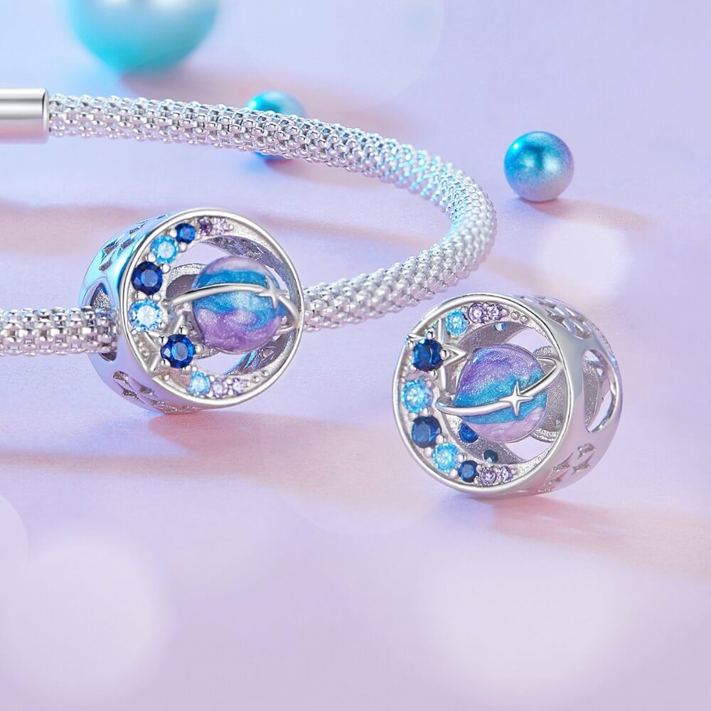 Sterling silver planet charm with blue purple crystals and sparkling star details.