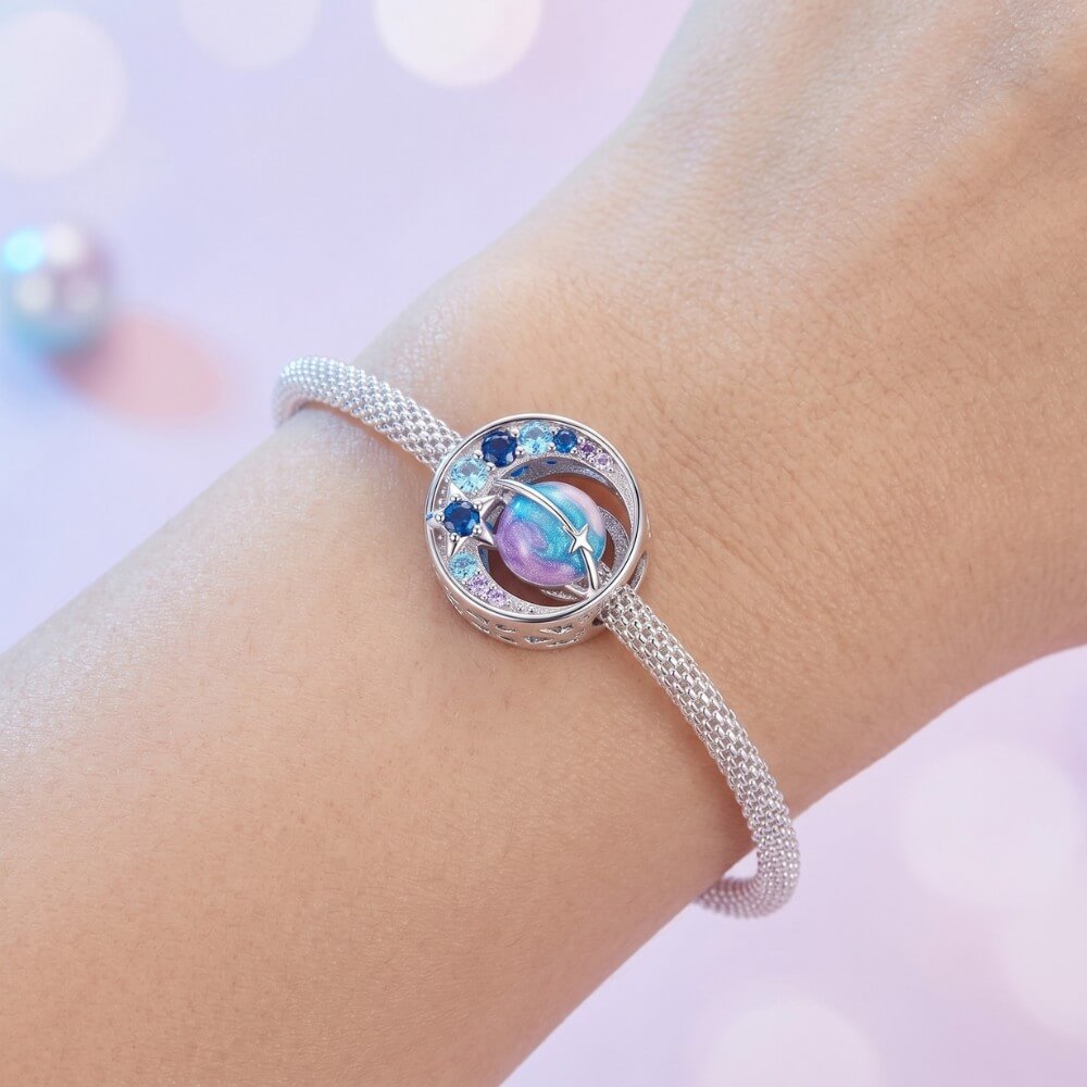 Sterling silver planet charm with blue purple crystals and sparkling star details.