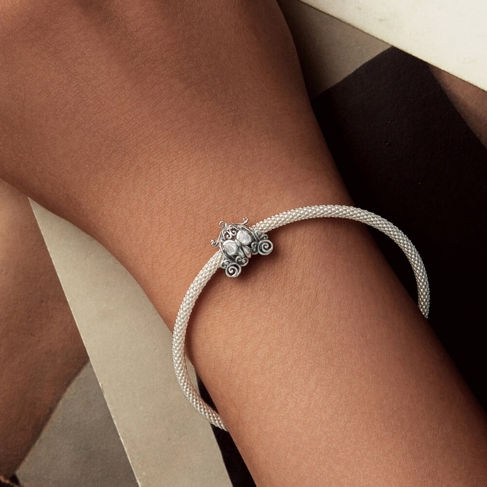 Sterling silver pumpkin carriage charm with heart-shaped crystals.