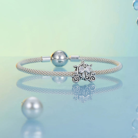 Sterling silver pumpkin carriage charm with heart-shaped crystals.