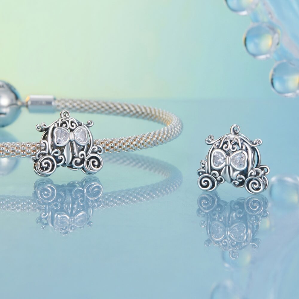 Sterling silver pumpkin carriage charm with heart-shaped crystals.