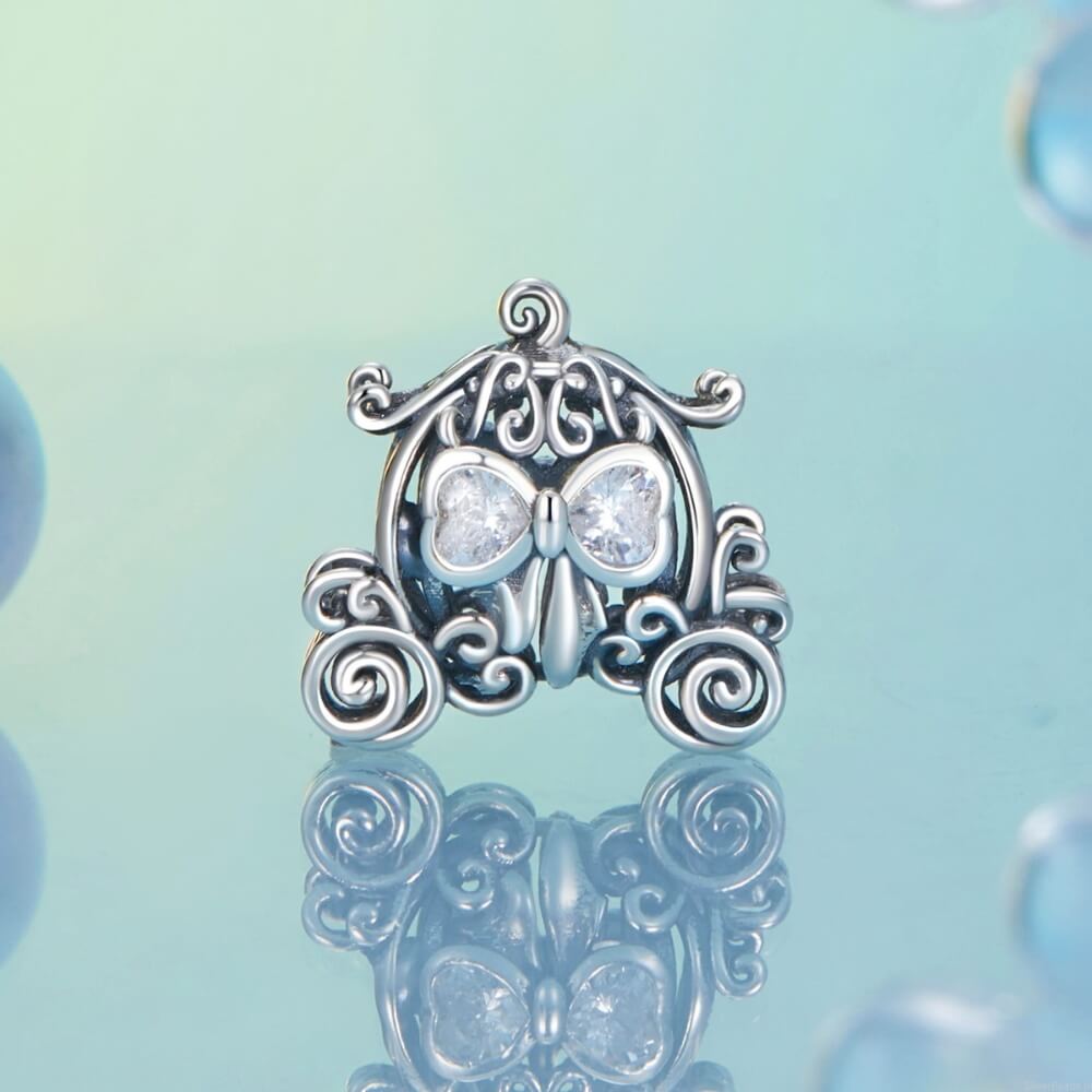 Sterling silver pumpkin carriage charm with heart-shaped crystals.