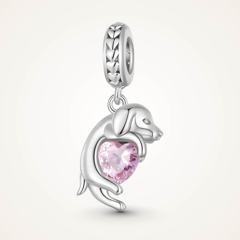 Sterling silver puppy charm hugging a pink heart-shaped stone – ORÉYA