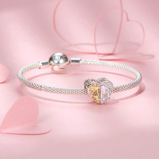 Sterling silver heart charm with golden crown detail and clear crystal.