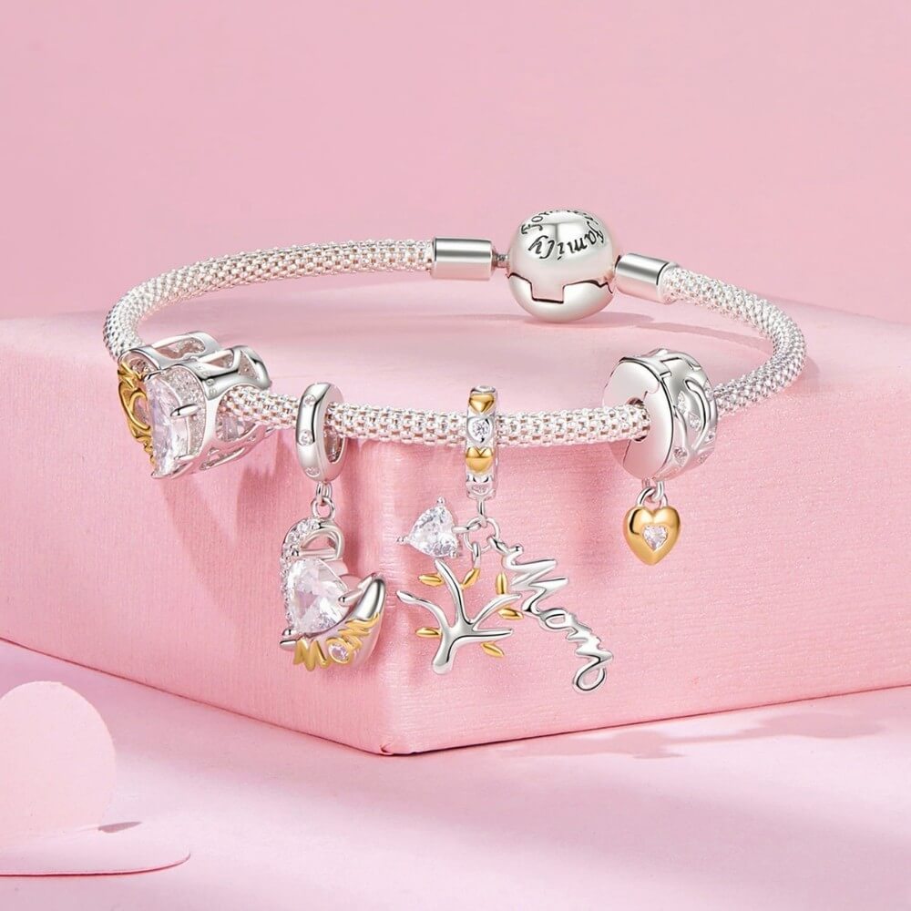 Sterling silver heart charm with golden crown detail and clear crystal.