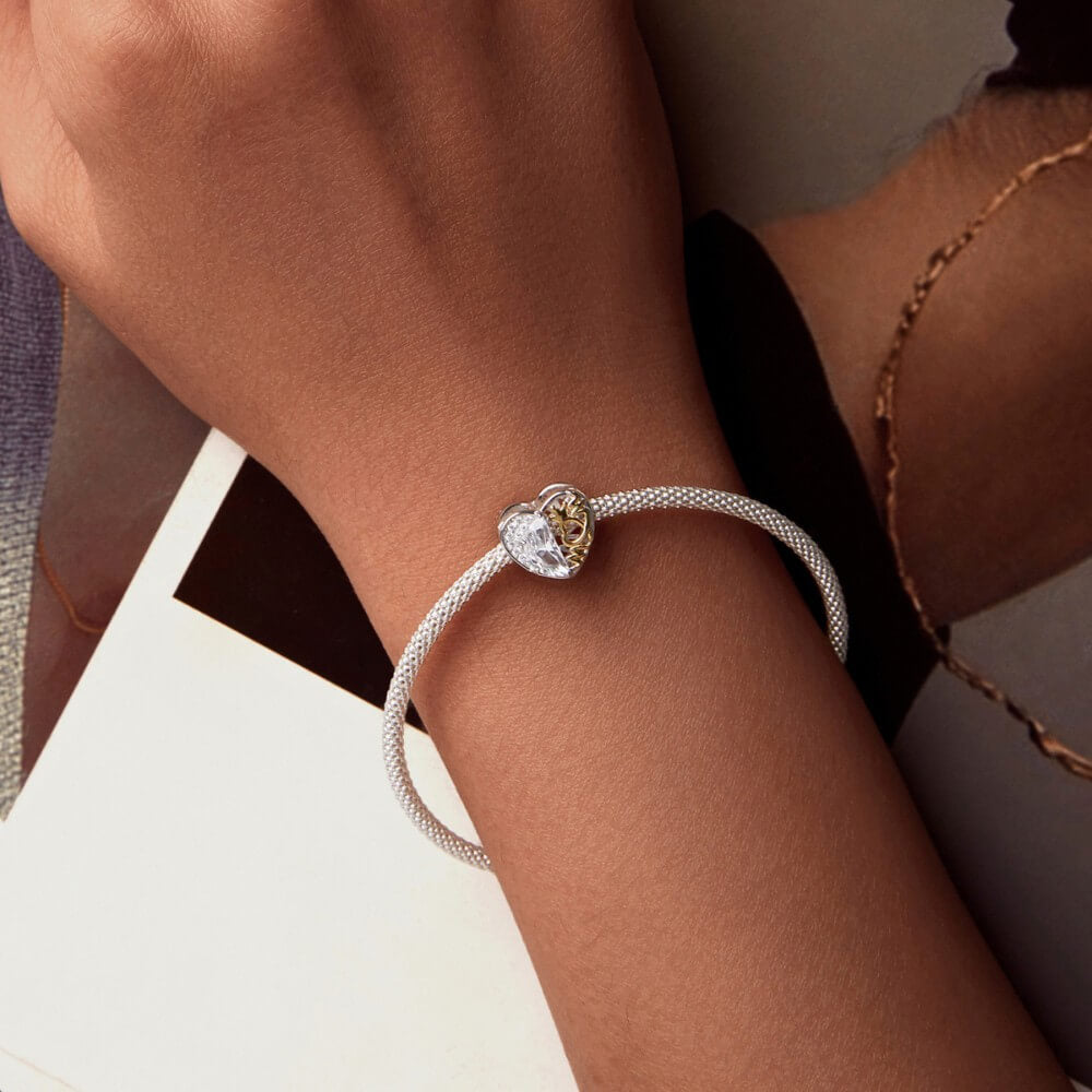 Sterling silver heart charm with golden crown detail and clear crystal.