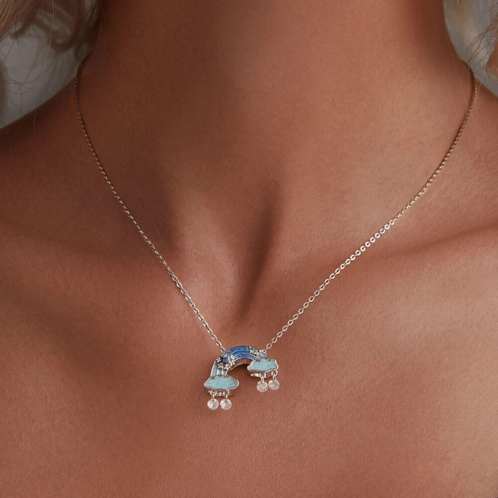 Sterling silver rainbow charm with clouds and dangling crystal drops.