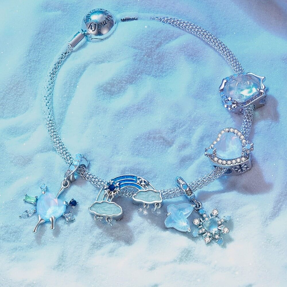 Sterling silver rainbow charm with clouds and dangling crystal drops.
