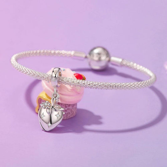 Sterling silver heart charm with red crystal center, floral details, stars, and a romantic double-heart design.