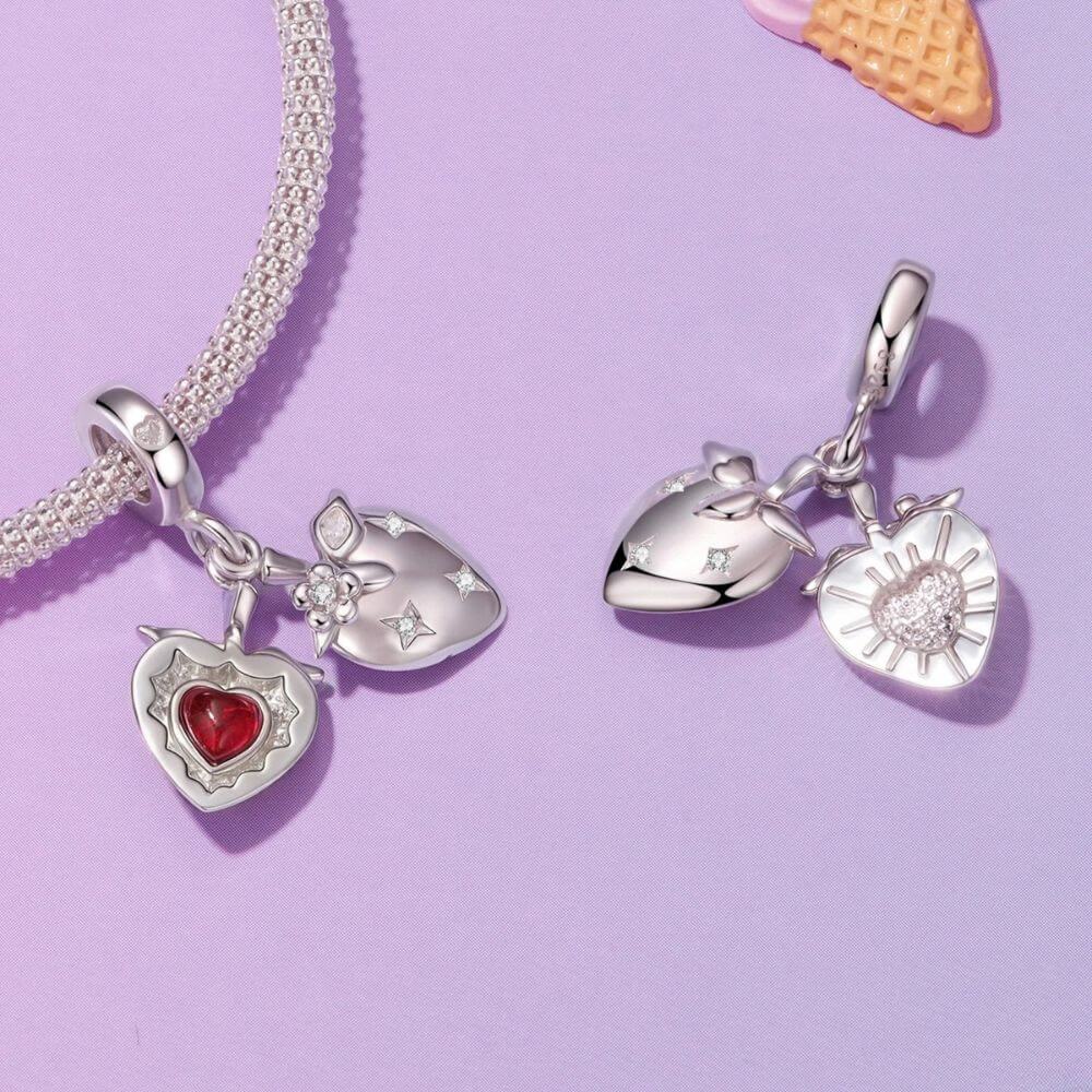 Sterling silver heart charm with red crystal center, floral details, stars, and a romantic double-heart design.