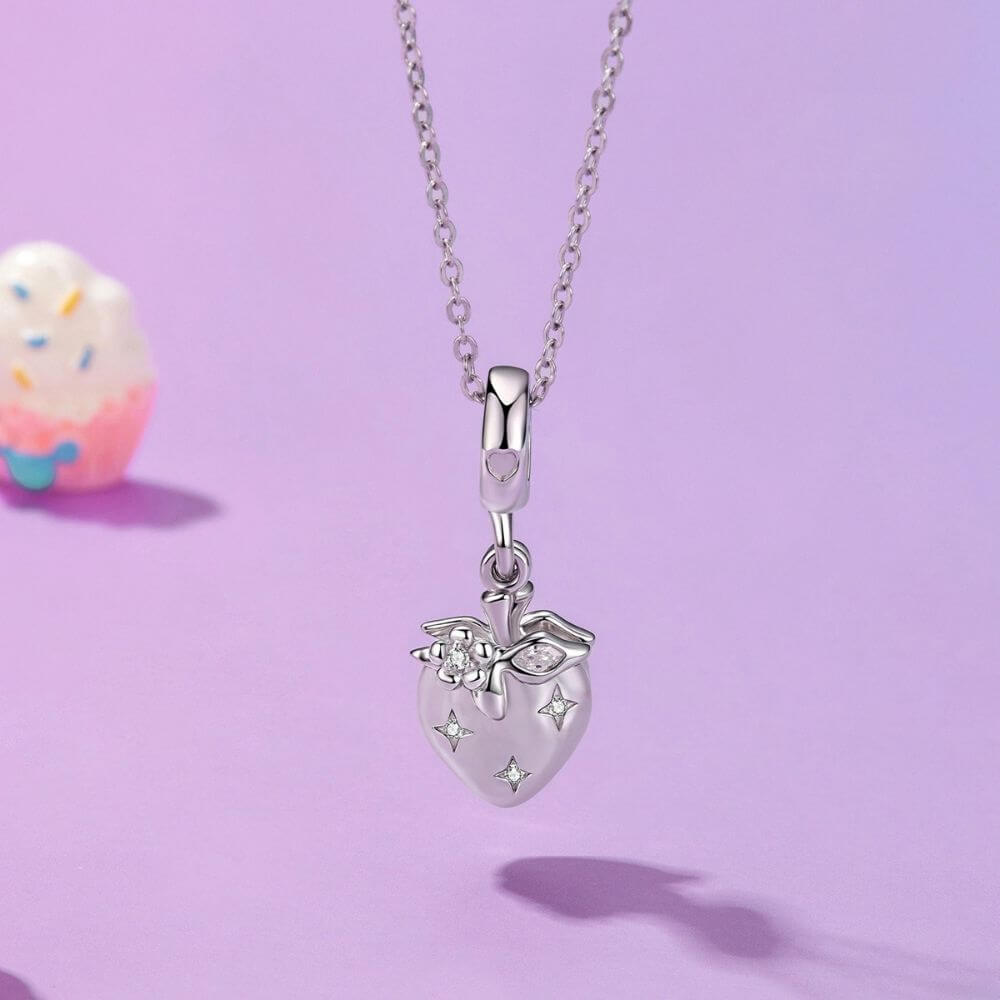Sterling silver heart charm with red crystal center, floral details, stars, and a romantic double-heart design.
