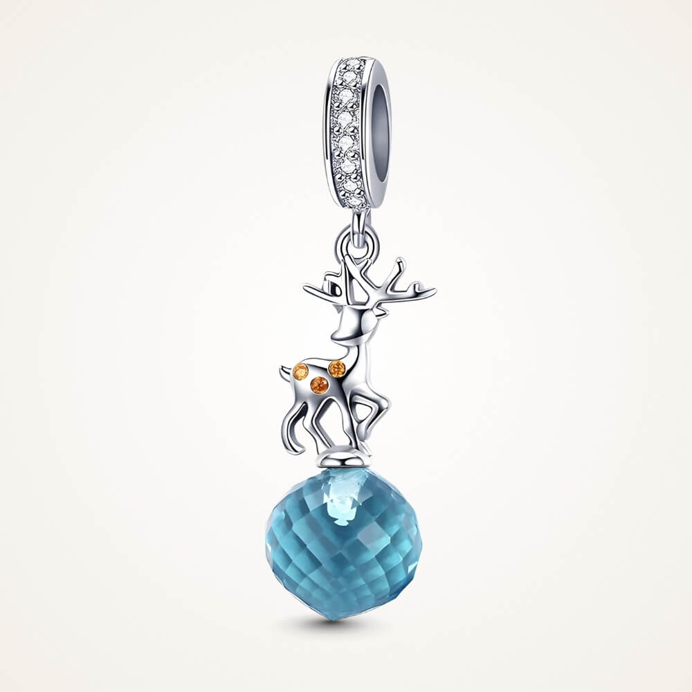 Sterling silver reindeer charm with orange gemstone spots and blue faceted crystal drop - ORÉYA