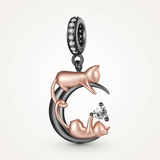 Rose gold cat moon charm with two playful cats, black crescent moon, and sparkling heart crystal detail - ORÉYA