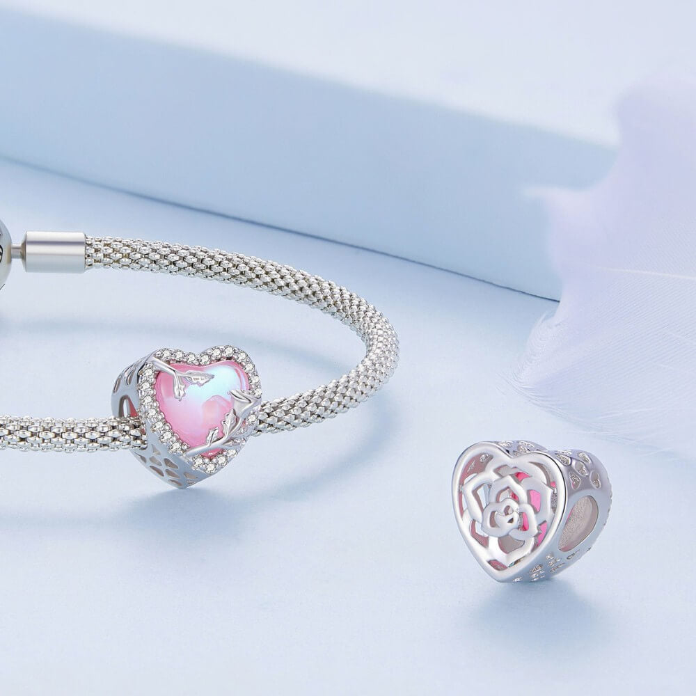 Sterling silver rose heart charm with pink opal center and crystal border.