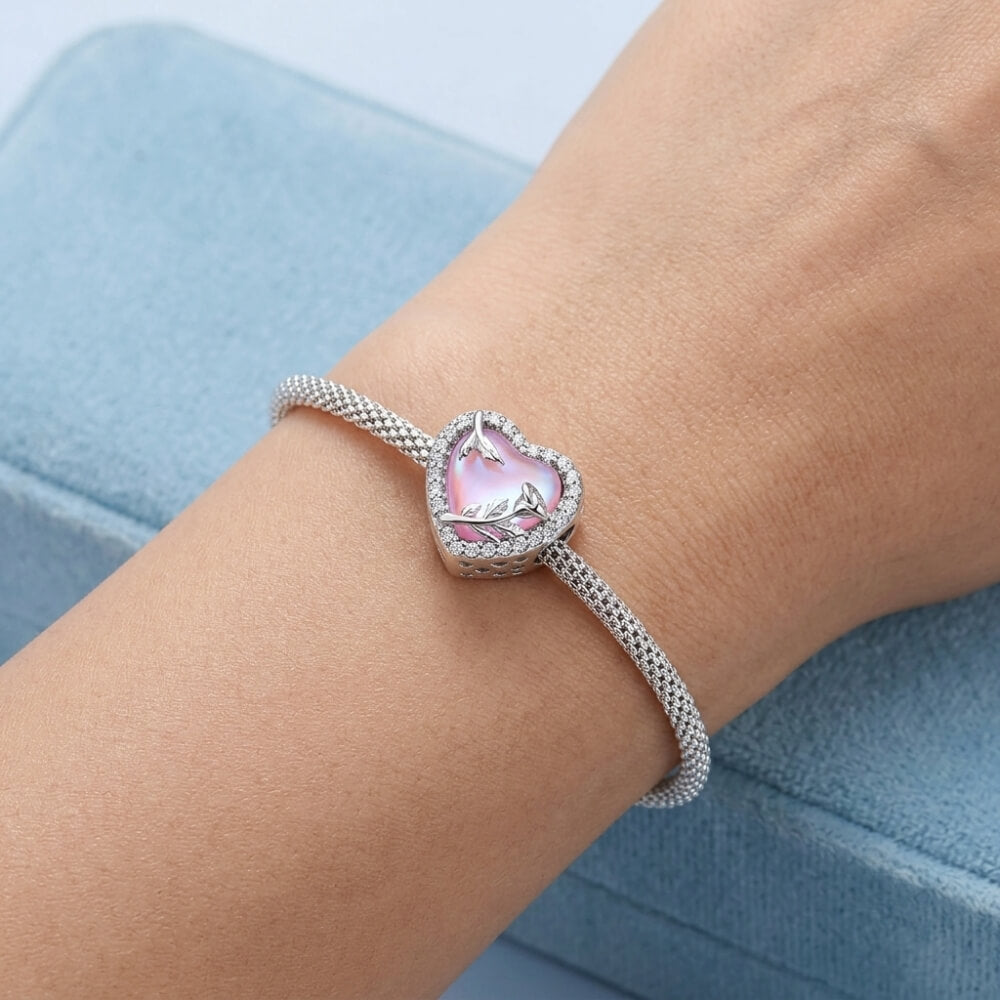 Sterling silver rose heart charm with pink opal center and crystal border.