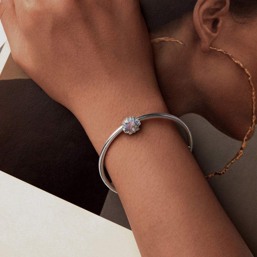 Sterling silver seashell charm with pastel enamel and crystal accents.