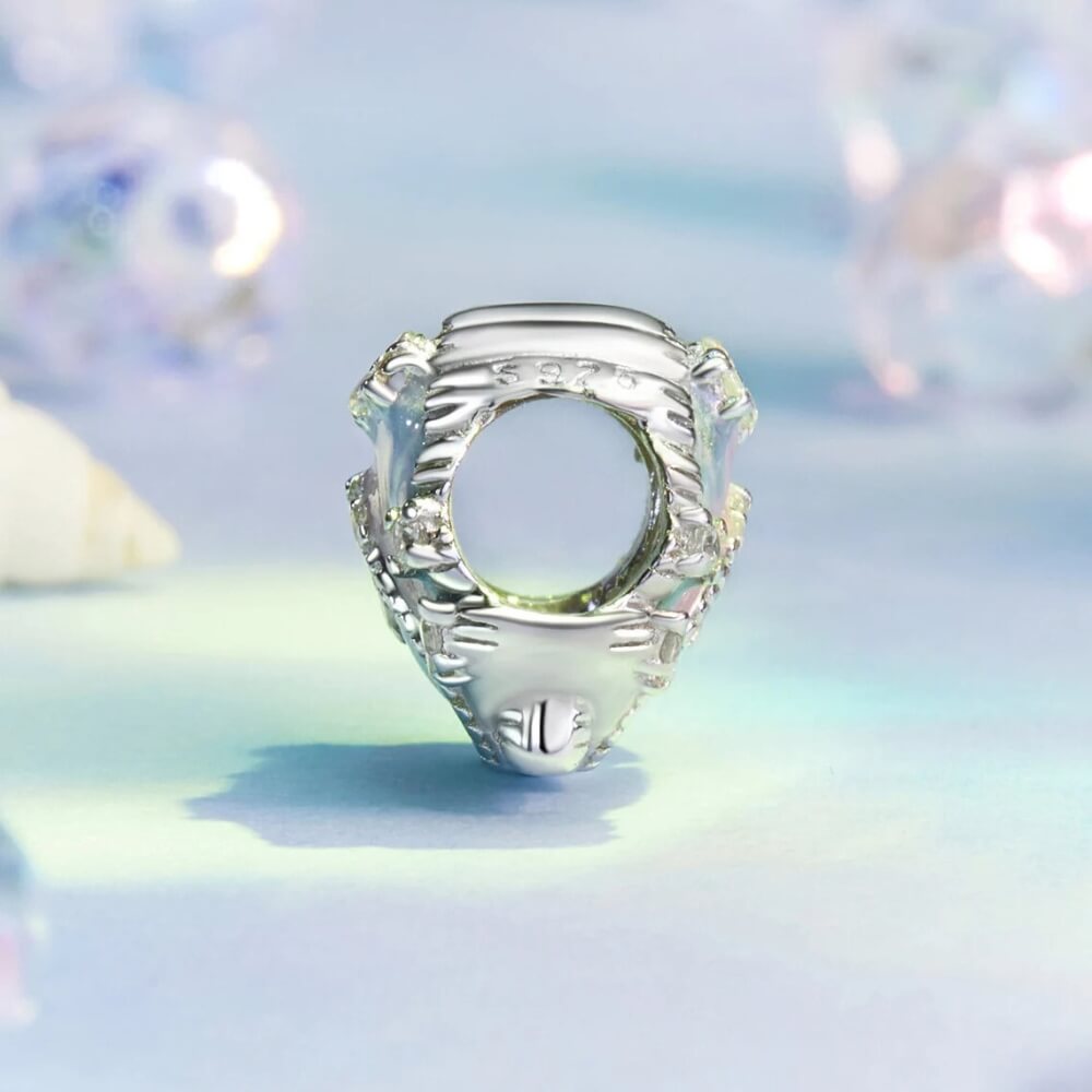 Sterling silver seashell charm with pastel enamel and crystal accents.