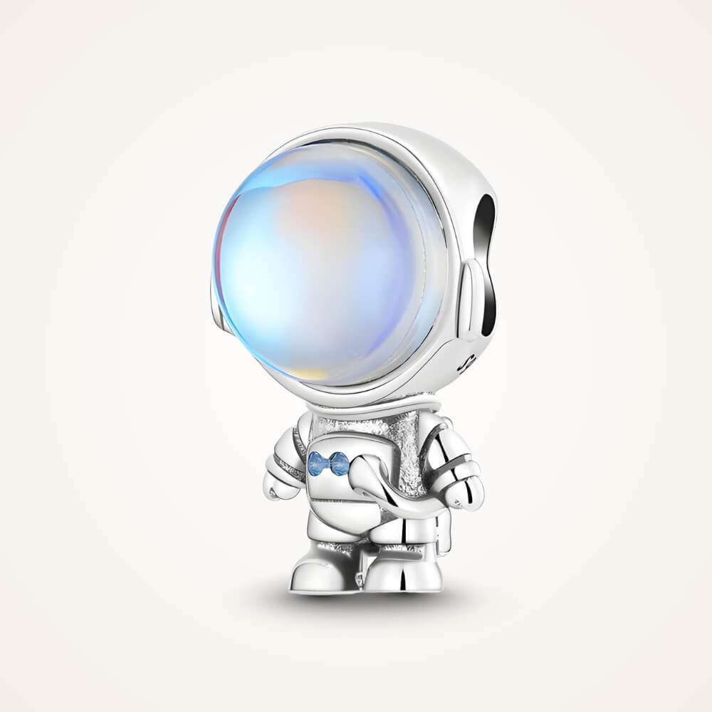 Sterling silver astronaut charm with a large iridescent glass helmet and small blue crystal details on the suit – ORÉYA