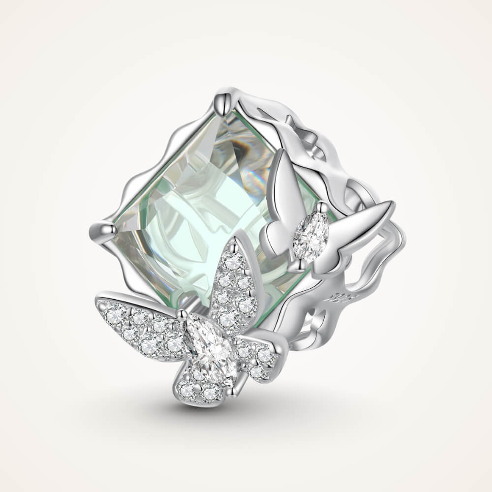 Sterling silver charm with a large pale green faceted stone and two crystal-studded silver butterflies on the front – ORÉYA