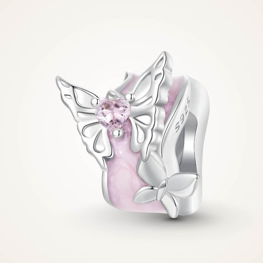 Sterling silver charm with a pale pink enamel background, a silver butterfly with a pink heart-shaped stone, and an additional silver flower detail – ORÉYA