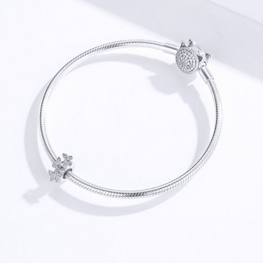 Sterling silver charm with three raised butterfly designs featuring detailed filigree wings 