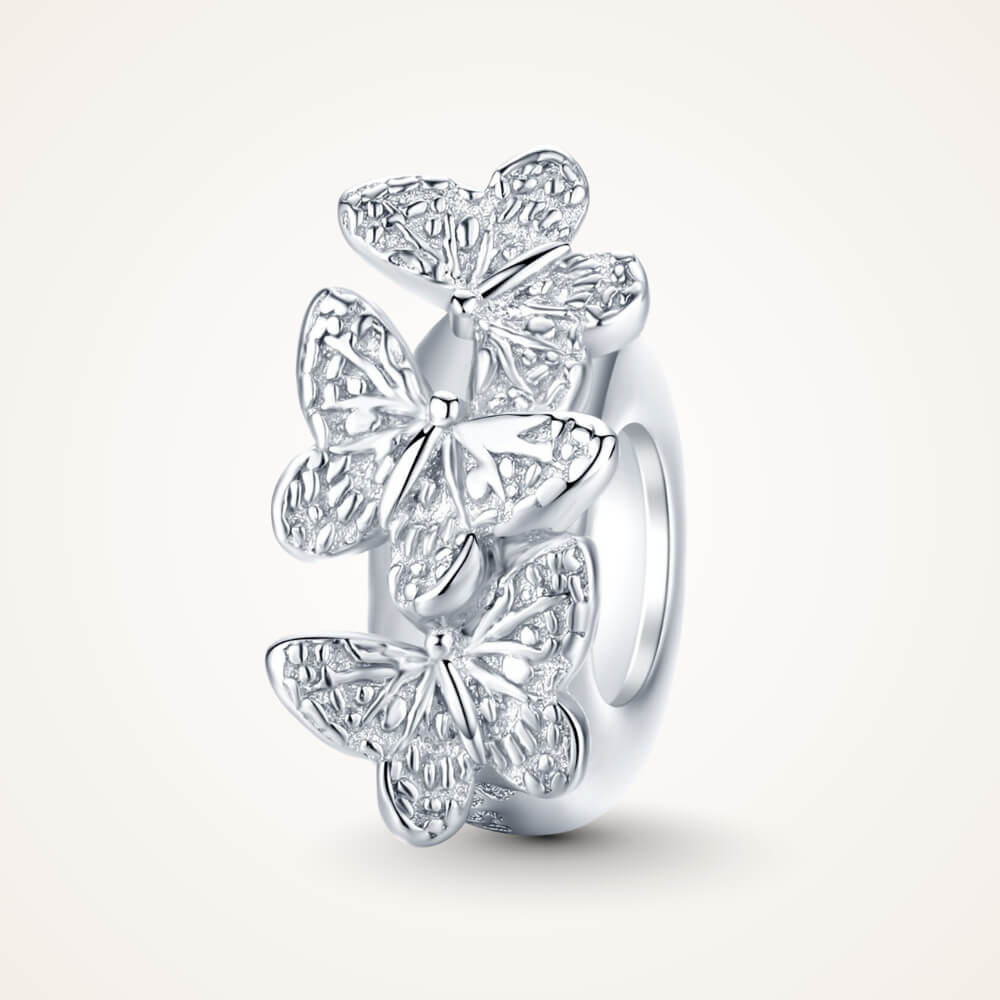 Sterling silver charm with three raised butterfly designs featuring detailed filigree wings – ORÉYA.
