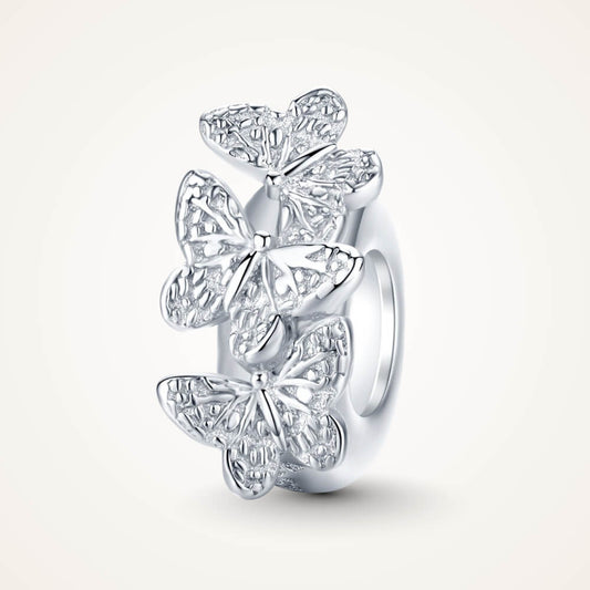 Sterling silver charm with three raised butterfly designs featuring detailed filigree wings – ORÉYA.