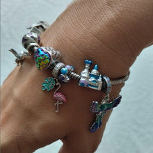 Sterling silver castle charm with blue enamel domes, glitter details, and shell accent.