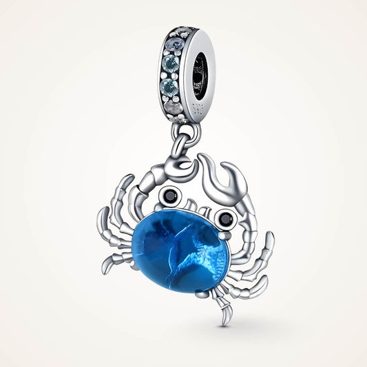 Sterling silver crab charm with a large blue oval stone body, black stone eyes, and a bail decorated with light-blue crystals – ORÉYA