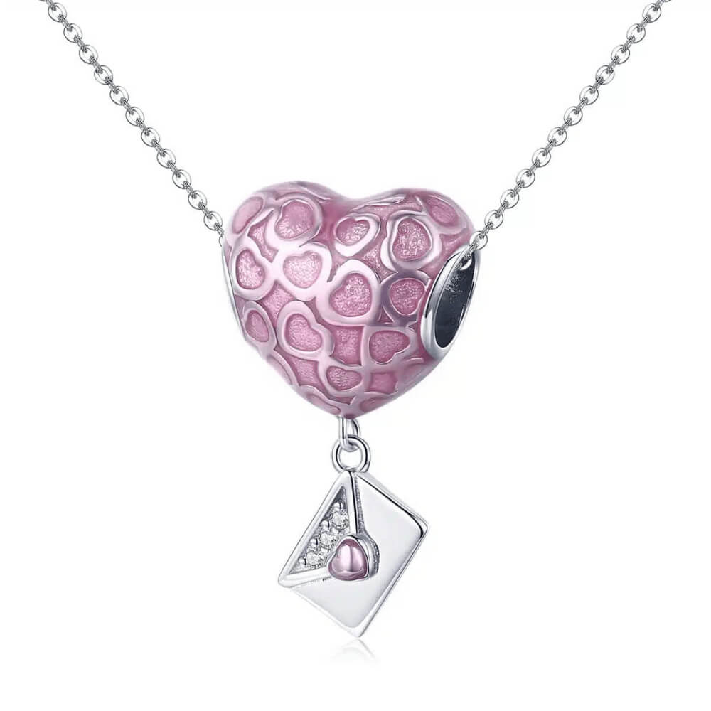 Sterling silver heart charm with pink enamel heart patterns and a dangling envelope accented with a small pink heart 