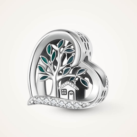 Sterling silver heart-shaped charm with a green-enamel tree, small house detail, and a row of clear crystals along the bottom – ORÉYA.
