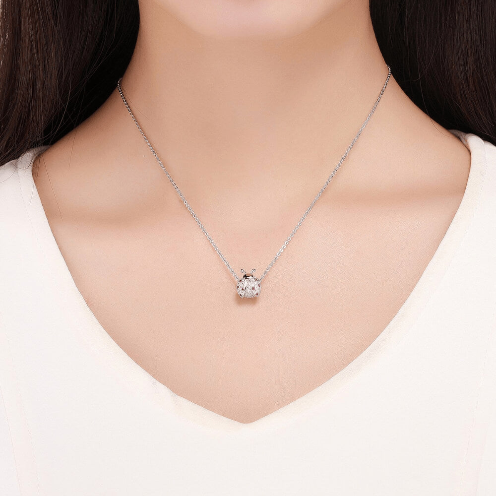 Sterling silver ladybug charm with pink and red crystals on the wings and clear stones on the body 