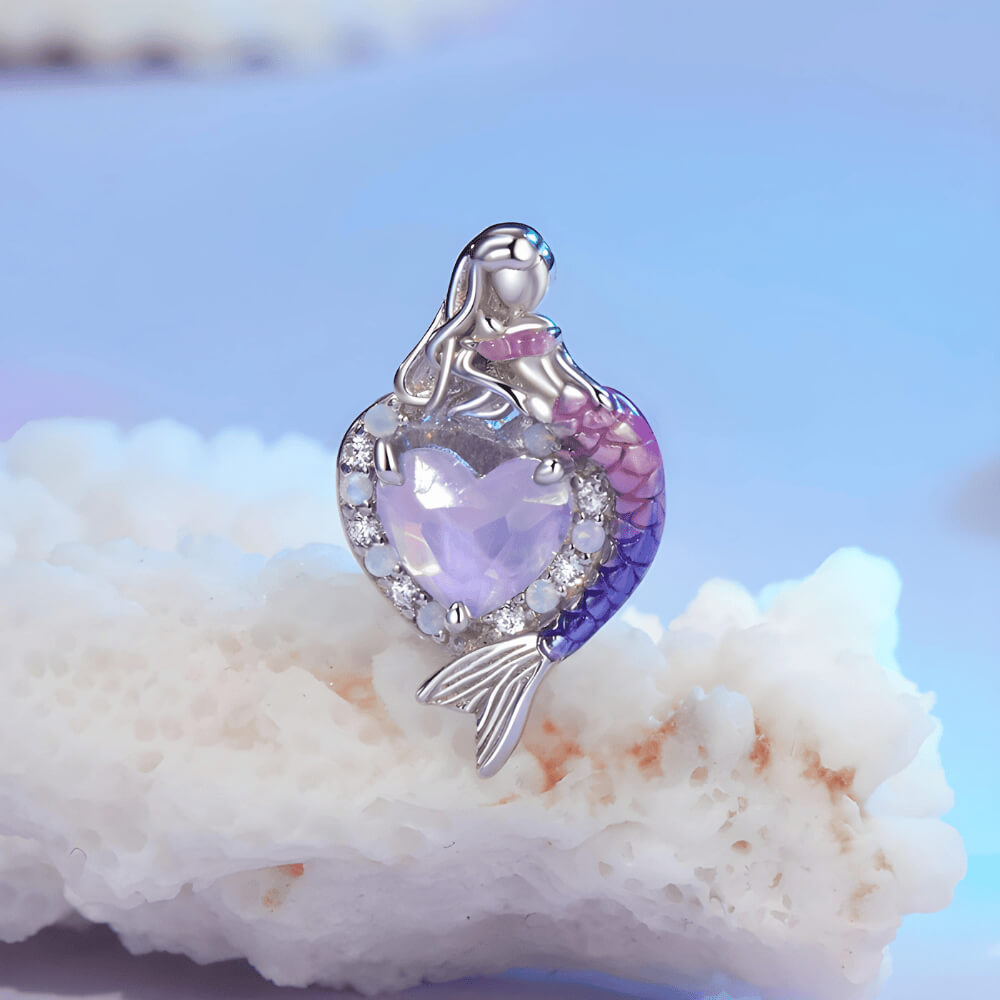 Sterling silver mermaid charm with a purple heart-shaped stone, crystal halo, and a gradient pink-to-blue enamel tail 