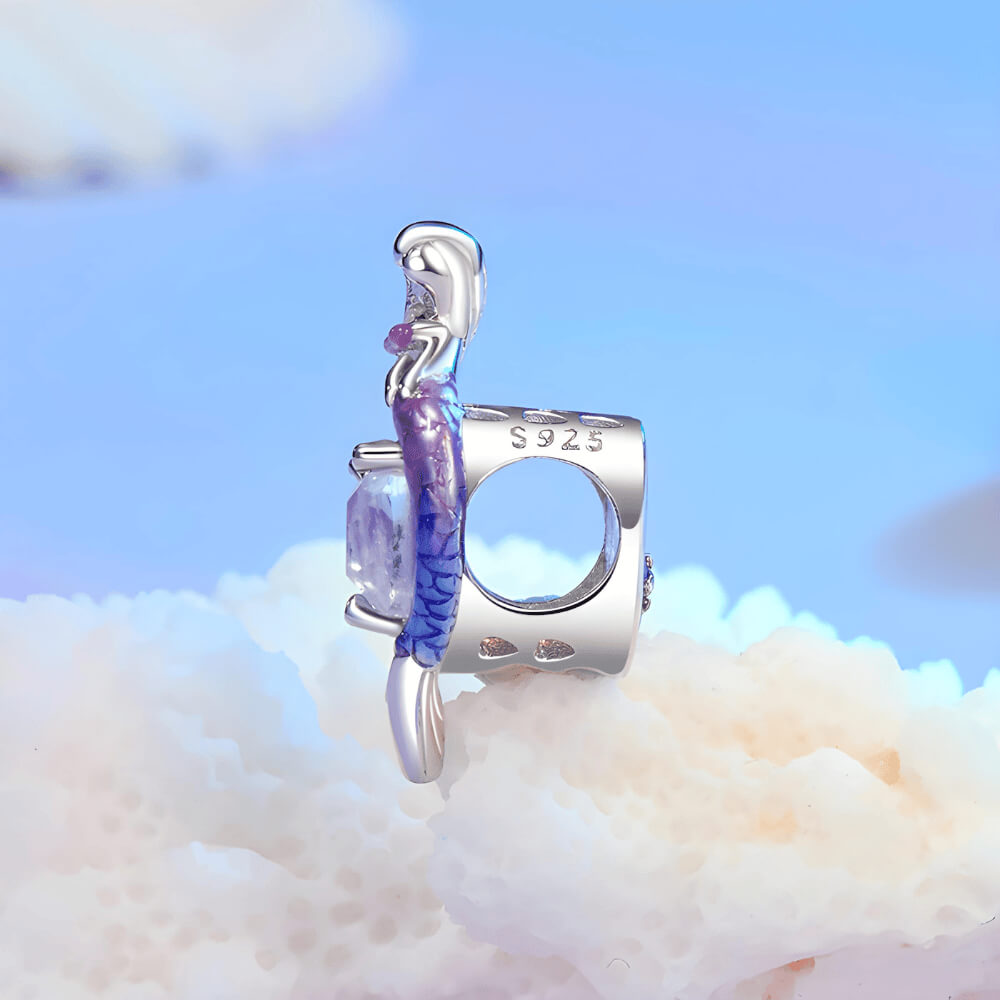 Sterling silver mermaid charm with a purple heart-shaped stone, crystal halo, and a gradient pink-to-blue enamel tail 