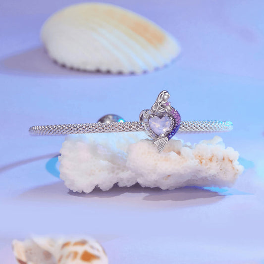 Sterling silver mermaid charm with a purple heart-shaped stone, crystal halo, and a gradient pink-to-blue enamel tail 