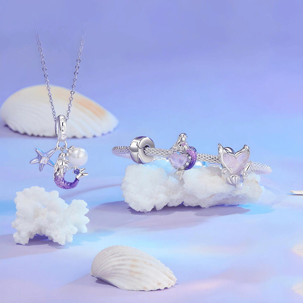 Sterling silver mermaid charm with a purple heart-shaped stone, crystal halo, and a gradient pink-to-blue enamel tail 