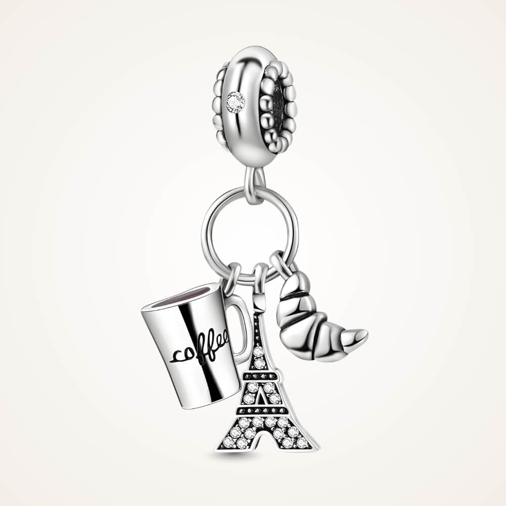 Sterling silver charm with three dangles: a coffee cup engraved with ‘coffee’, a croissant, and a crystal-studded Eiffel Tower – ORÉYA