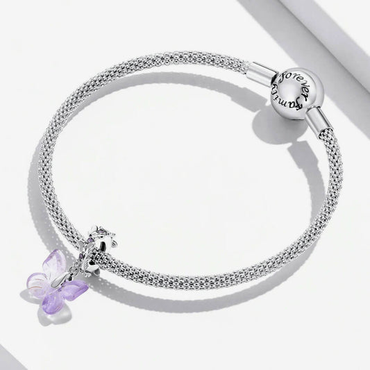 Sterling silver charm with a pale purple glass butterfly pendant and a butterfly-shaped bail decorated with small purple stones