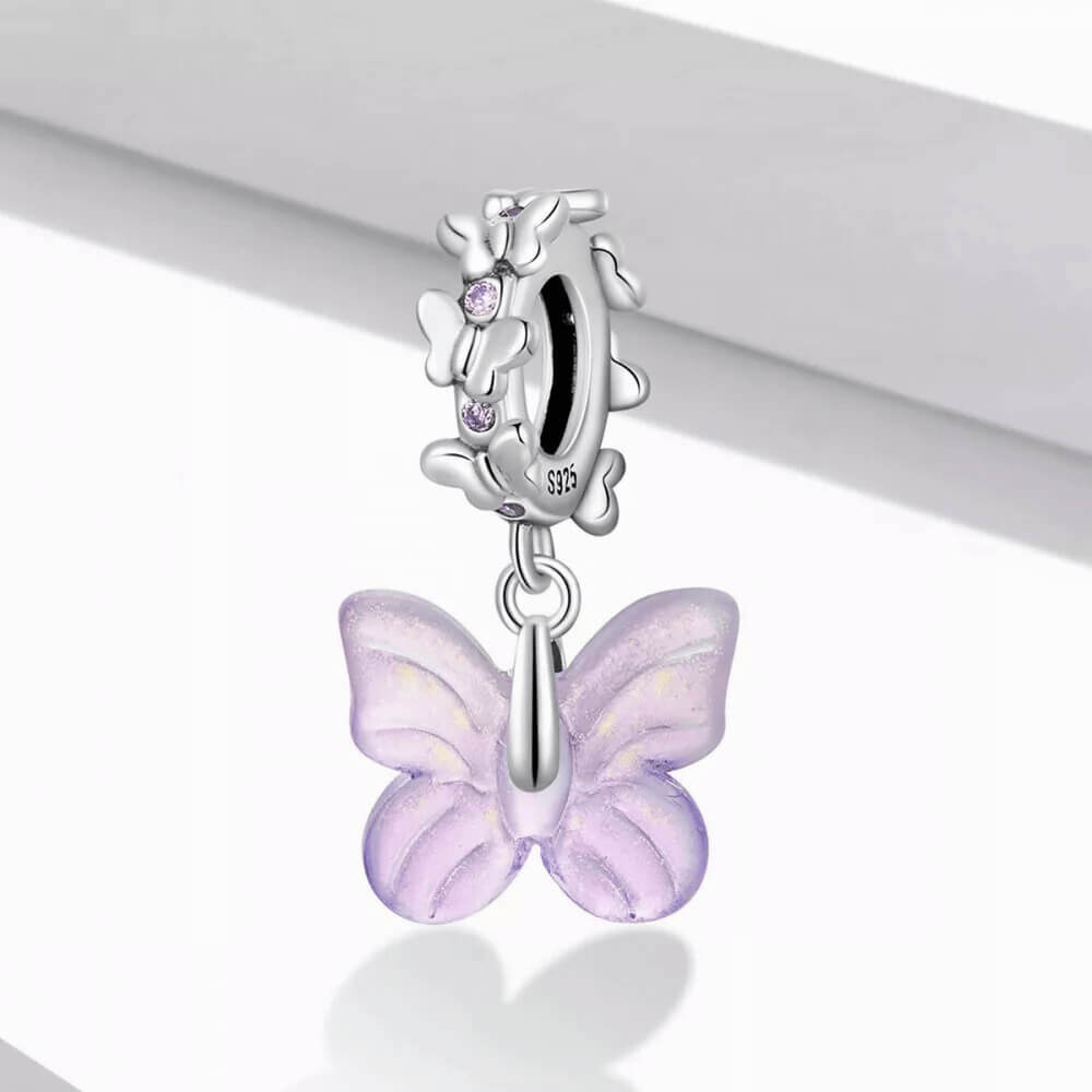 Sterling silver charm with a pale purple glass butterfly pendant and a butterfly-shaped bail decorated with small purple stones