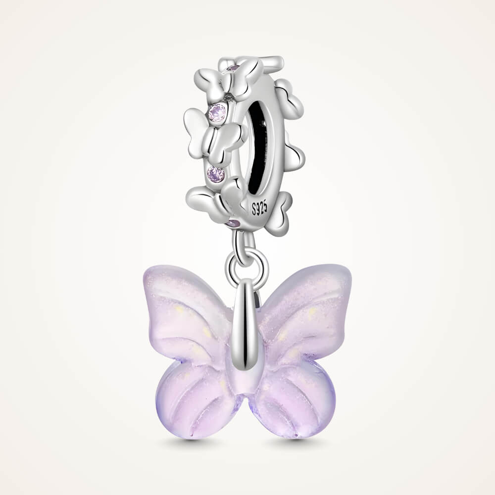 Sterling silver charm with a pale purple glass butterfly pendant and a butterfly-shaped bail decorated with small purple stones – ORÉYA.