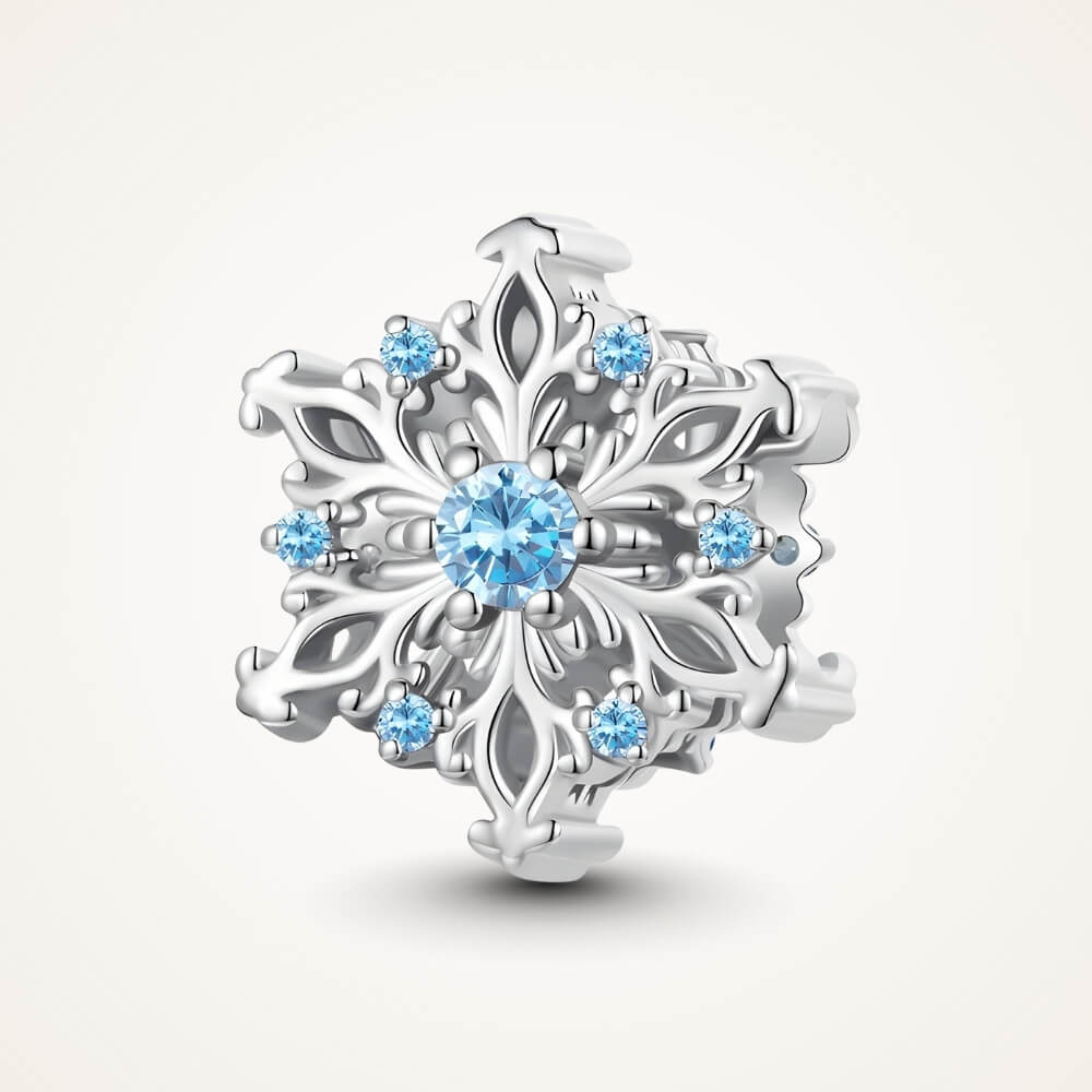 Sterling silver snowflake charm with detailed openwork design and light blue gemstones - ORÉYA