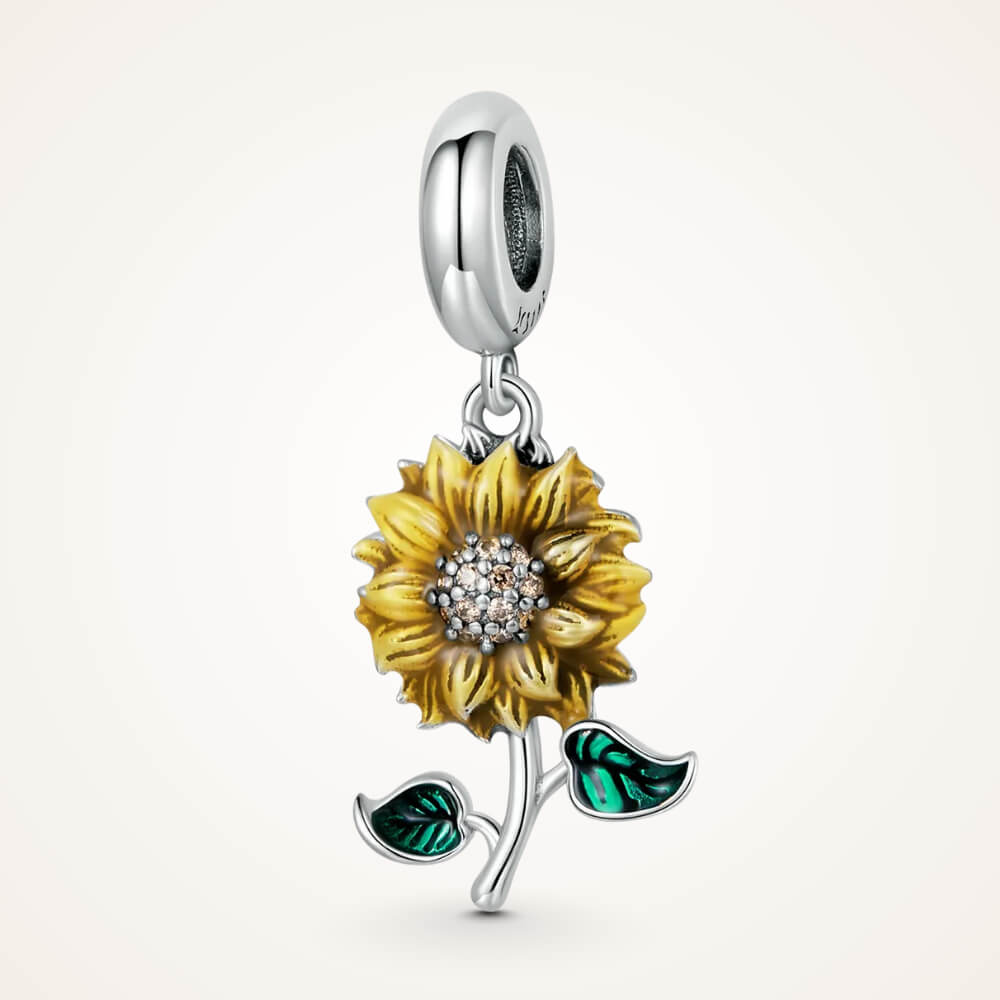 Sterling silver sunflower charm with yellow enamel petals, a crystal-studded center, and two green enamel leaves – ORÉYA