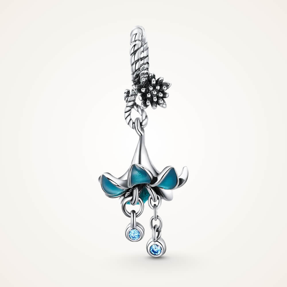 Sterling silver charm with a flower-shaped umbrella design, teal enamel petals, and two dangling blue crystals – ORÉYA.