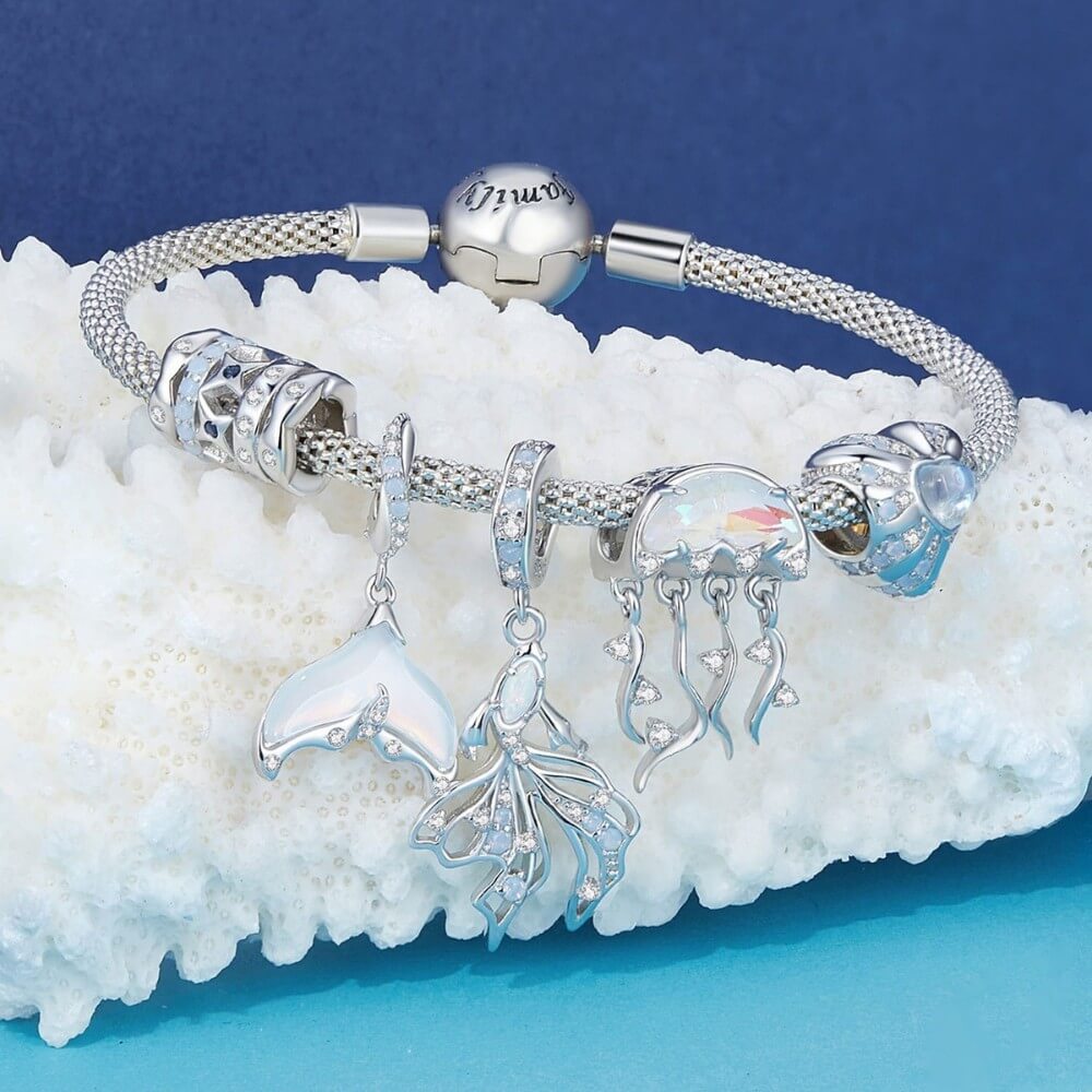 Sterling silver siren tail charm with iridescent enamel and crystals.