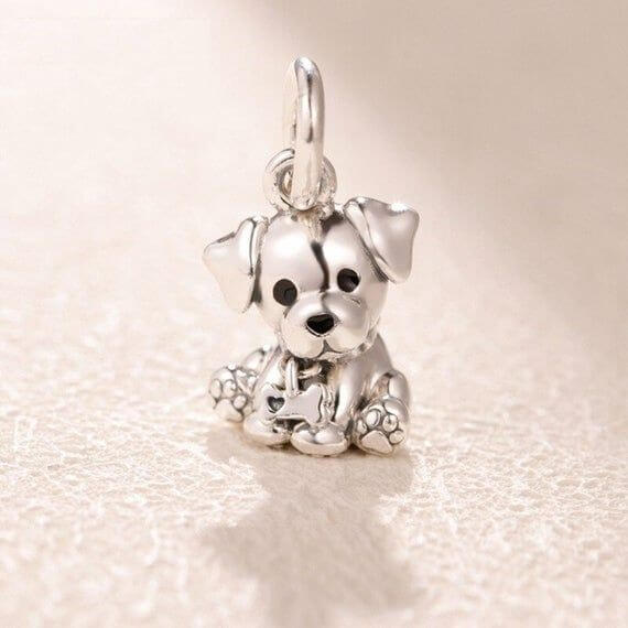 Sterling silver sitting puppy charm with dangling bone detail