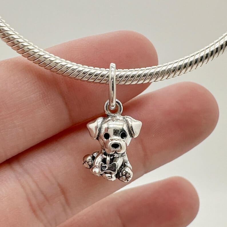 Sterling silver sitting puppy charm with dangling bone detail