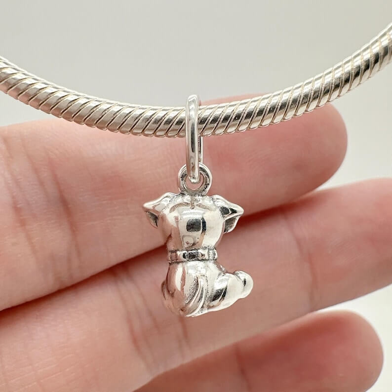 Sterling silver sitting puppy charm with dangling bone detail