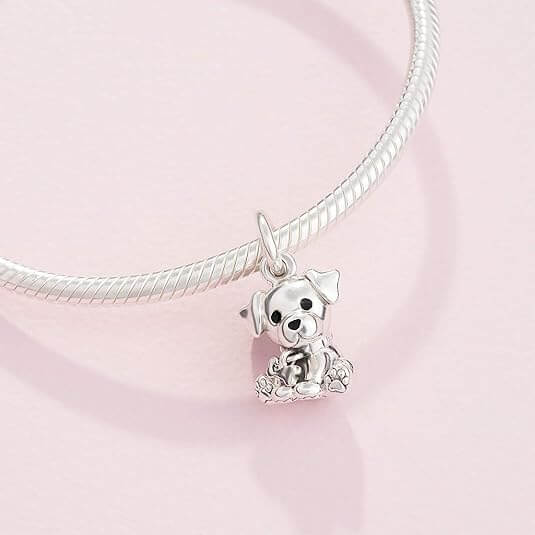 Sterling silver sitting puppy charm with dangling bone detail