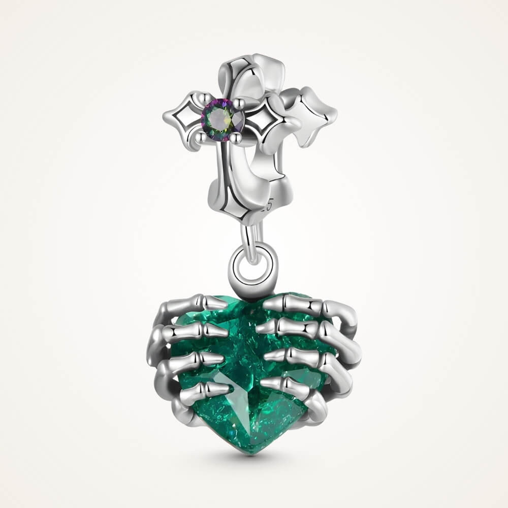 Sterling silver skeleton heart charm with emerald crystal and gothic details.