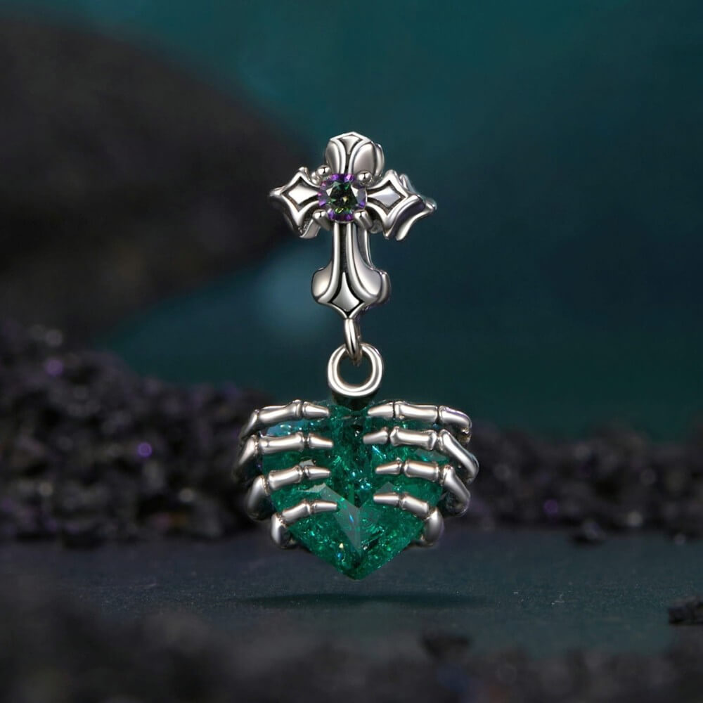 Sterling silver skeleton heart charm with emerald crystal and gothic details.